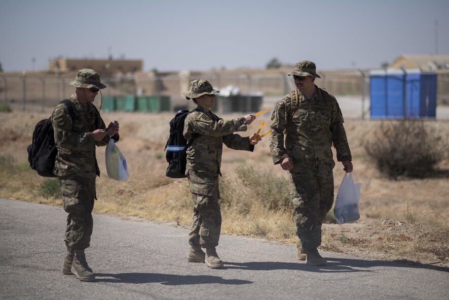 An Airman gives freeze pops to her friends June 2, 2017, in Southwest Asia. The pops were delivered by the 332nd Air Expeditionary Wing Religious Support Team as a morale boost to Airmen. (U.S. Air Force photo/Senior Airman Damon Kasberg)