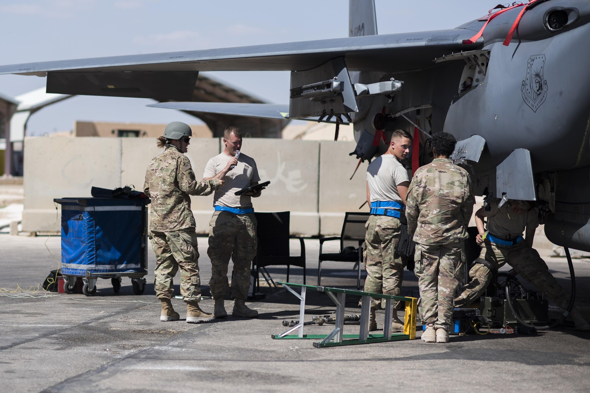Tech Sgt. Nikki Webb, 332nd Air Expeditionary Wing Airmen ministry center non-commissioned officer in charge, hands out freeze pops to Airmen working on the flight line, June 2, 2017, in Southwest Asia. Webb and other members of the religious support team deliver the frozen treats on Fridays to Airmen working throughout the installation. (U.S. Air Force photo/Senior Airman Damon Kasberg)