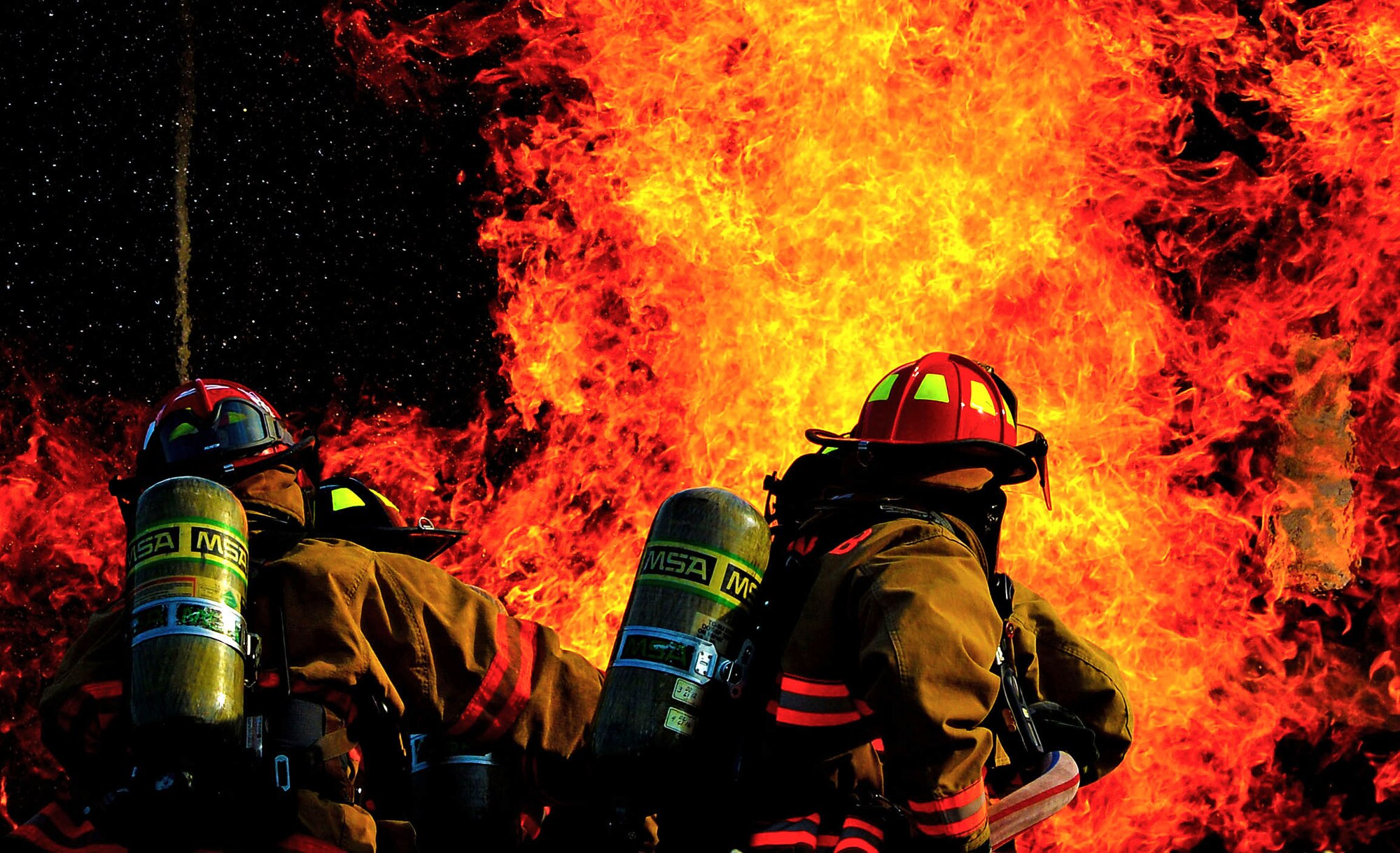 U.S. Airmen assigned to the 20th Civil Engineer Squadron fire department extinguish a fire during a live fire training scenario at Shaw Air Force Base, S.C., June 27, 2017. The training enables firefighters to hone the skills needed to combat aircraft fires, structural fires and vehicle extractions. (U.S. Air Force photo by Senior Airman Christopher Maldonado)