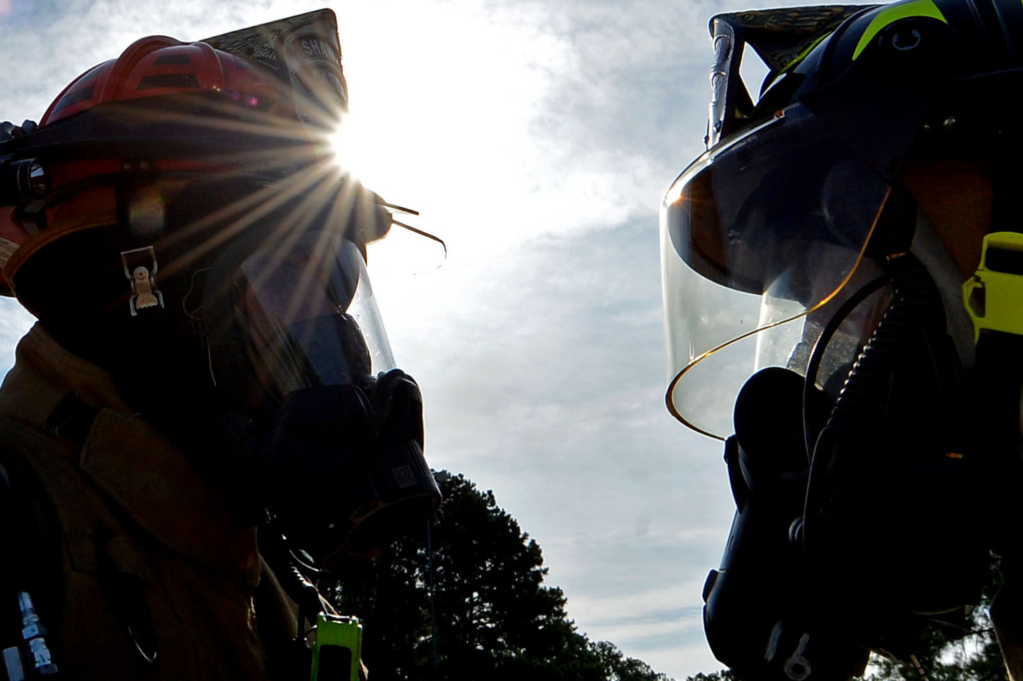 U.S. Air Force Staff Sgt. Christian Arvelo, 20th Civil Engineer Squadron fire department driver operator, left, inspects the gear of Chief Master Sgt. Daniel Hoglund, 20th Fighter Wing command chief, after combating a simulated C-130 Hercules fire at Shaw Air Force Base, S.C., June 27, 2017. Firefighters perform “buddy checks” before and after extinguishing fires to ensure all equipment is functioning properly and to prevent hazardous fumes from entering the gear. (U.S. Air Force photo by Senior Airman Christopher Maldonado)