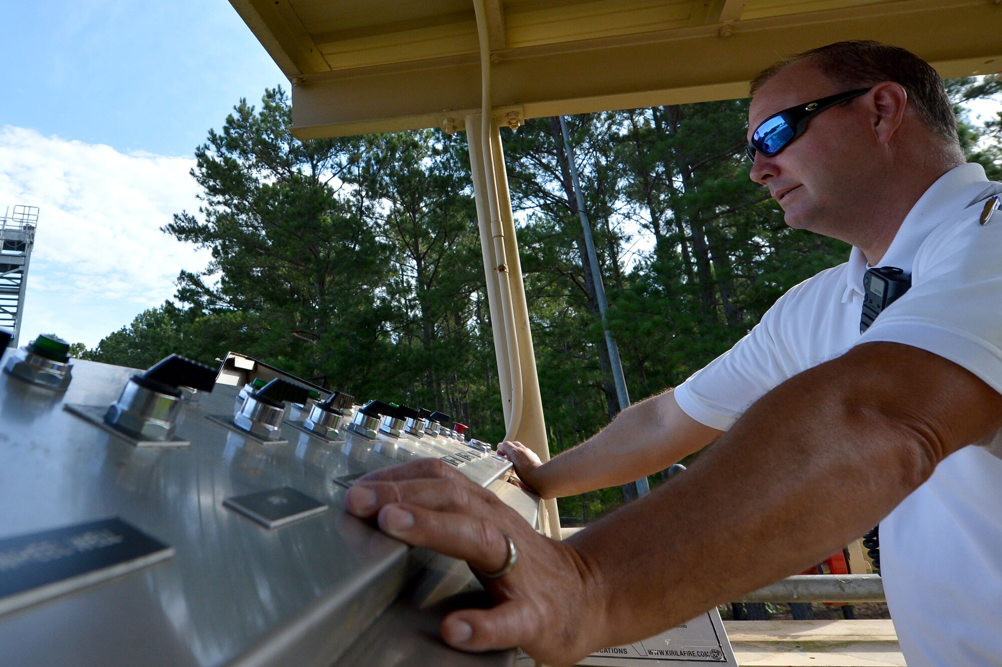 Gregory Farley, 20th Civil Engineer Squadron fire department assistant fire chief, controls the mock C-130 Hercules aircraft fire site lighting mechanism at Shaw Air Force Base, S.C., June 27, 2017. The mechanism controls the locations of the fires on the C-130 by supplying the sparks needed to ignite fumes. (U.S. Air Force photo by Senior Airman Christopher Maldonado)
