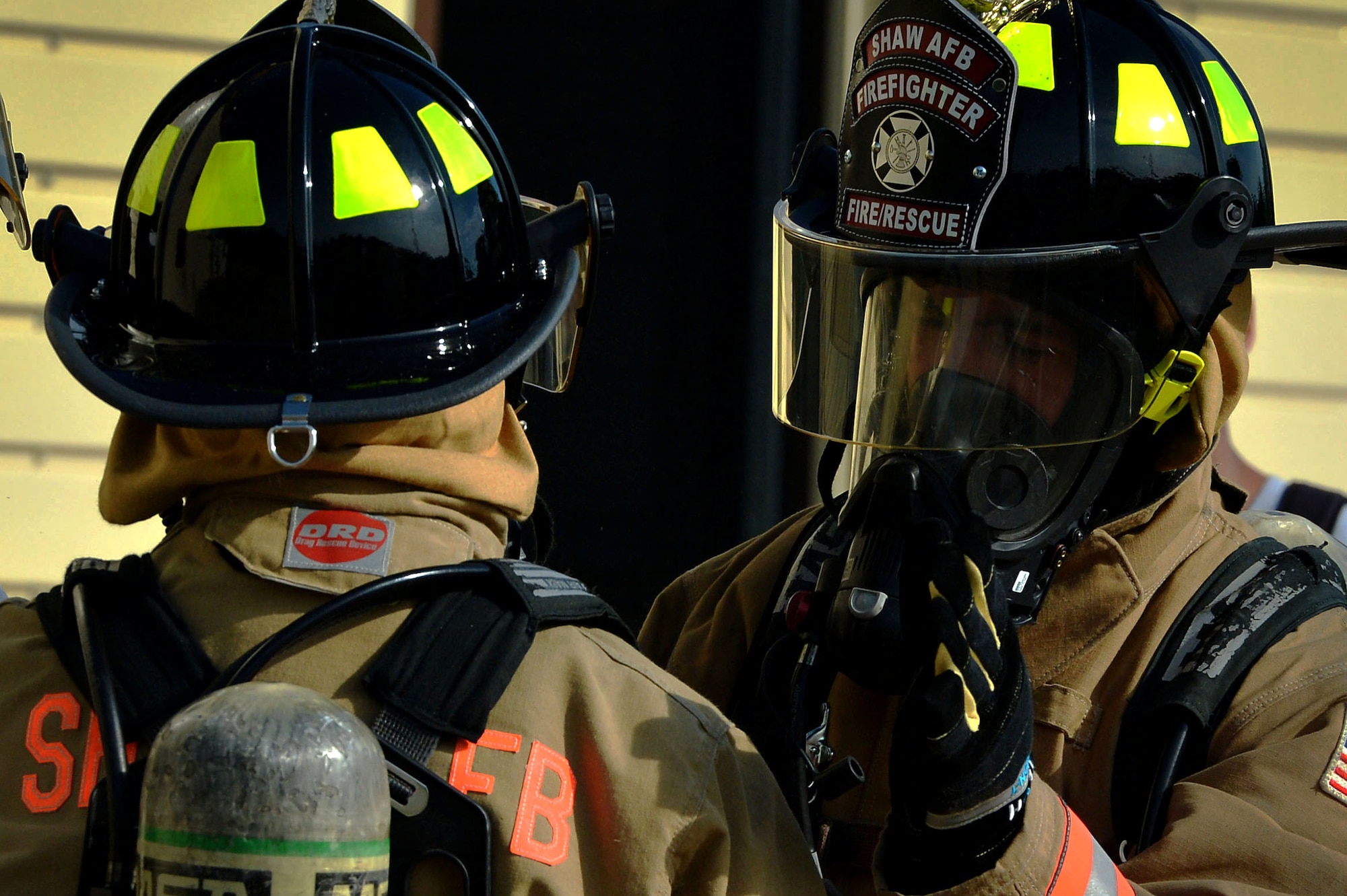 U.S. Airmen assigned to the 20th Civil Engineer Squadron fire department regroup after extinguishing a live structure fire at Shaw Air Force Base, S.C., June 27, 2017. The two and a half story structure fire trainer consists of burn rooms, specially insulated to contain fires. (U.S. Air Force photo by Senior Airman Christopher Maldonado)