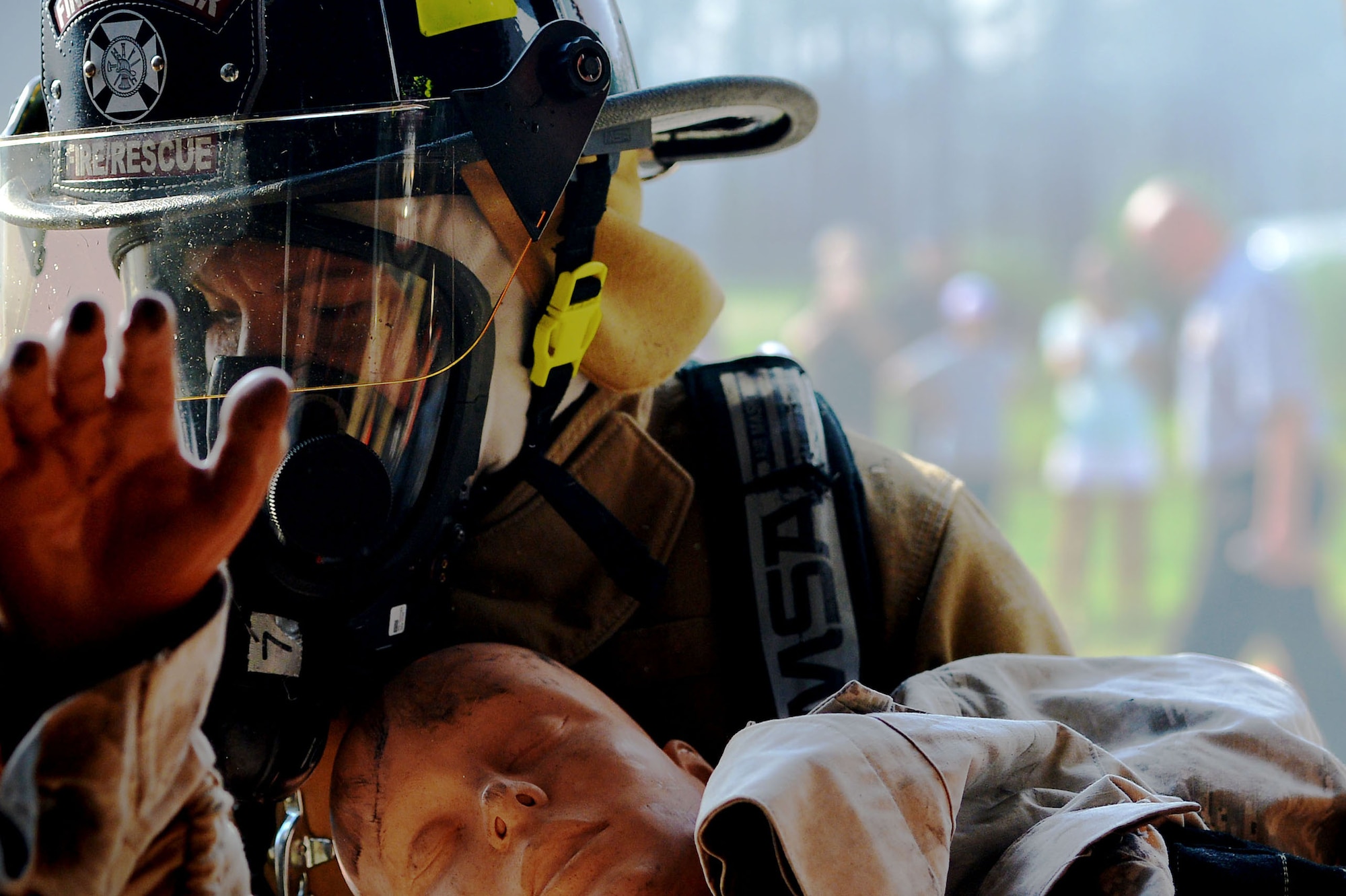 A U.S. Airman assigned to the 20th Civil Engineer Squadron fire department drags a simulated casualty from a structure fire during a live fire training scenario at Shaw Air Force Base, S.C., June 27, 2017. Firefighters worked as a team to operate sprinkler systems, ventilate rooftops, and perform search and rescue operations during the training. (U.S. Air Force photo by Senior Airman Christopher Maldonado)