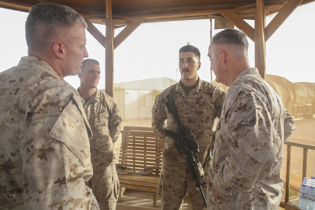 Gen. Joseph F. Dunford Jr., right, the Chairman of the Joint Chiefs of Staff, speaks with Marines assigned to Task Force Southwest at Camp Shorab, Afghanistan, June 28, 2017. Dunford awarded several Marines challenge coins for their hard work and commitment.  He also met with unit’s leadership to discuss the progress and challenges of the Task Force’s train, advise and assist mission in Helmand Province. (U.S. Marine Corps photo by Sgt. Lucas Hopkins)