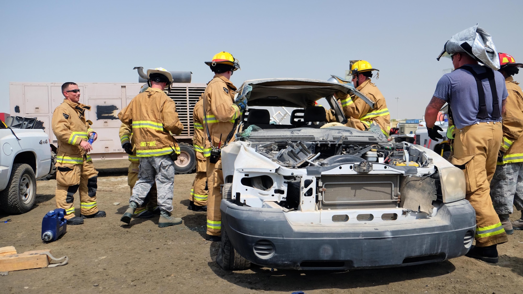Airmen with the 380th Expeditionary Civil Engineer Squadron Fire Department remove a vehicle's canopy June 23, 2017, at an undisclosed location in southwest Asia. As part of vehicle extrication training, all six supports were cut to remove the canopy and access the passenger compartment. (U.S. Air Force photo by Senior Airman Preston Webb)