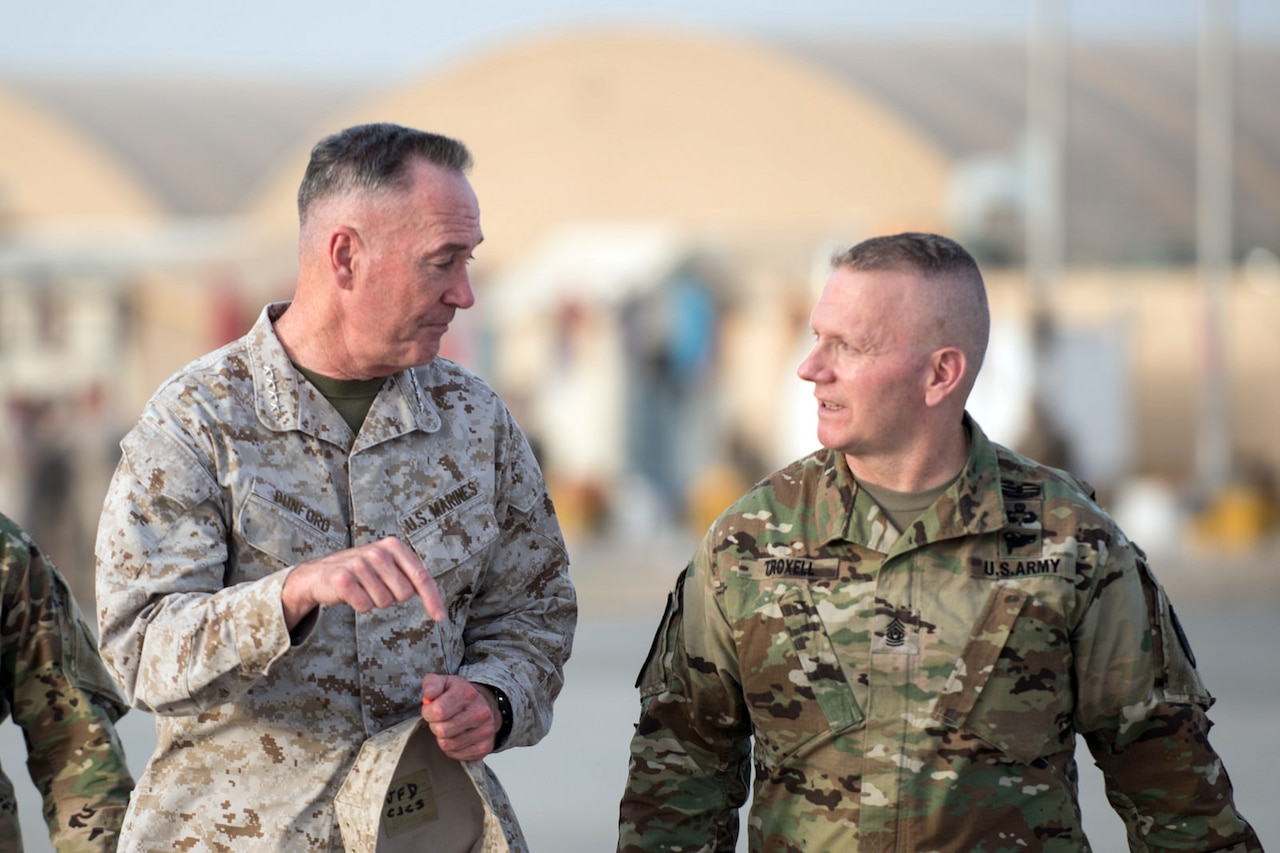 Marine Corps Gen. Joe Dunford, chairman of the Joint Chiefs of Staff, speaks with Army Command Sgt. Maj. John W. Troxell, senior enlisted advisor to the Chairman of the Joint Chiefs of Staff, after a visit to Train, Advise, Assist Command in Helmand Province, Afghanistan, June 28, 2017. Gen. Dunford traveled throughout the country meeting with U.S., coalition, and Afghan leaders. DoD photo by Army Sgt. James K. McCann