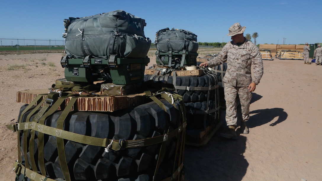U.S Marine Pfc. Brad A. Clark inspects the rigged aerial delivery systems of Joint Precision Airdrop Systems during a Weapons and Training Instructor Course March 30, 2017, at Marine Corps Air Station Yuma, Ariz. The JPADS systems use GPS, a modular autonomous guidance unit, or MAGU, a parachute and electric motors to guide cargo within 150 meters of their target points. Marine Corps Systems Command fielded the last of 162 JPADS to the fleet in April, turning the page from acquisition to sustainment of the system for the Corps. (U.S. Marine Corps photo by Lance Cpl. Jocelyn Ontiveros)