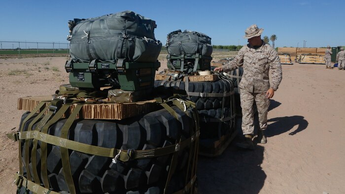 U.S Marine Pfc. Brad A. Clark inspects the rigged aerial delivery systems of Joint Precision Airdrop Systems during a Weapons and Training Instructor Course March 30, 2017, at Marine Corps Air Station Yuma, Ariz. The JPADS systems use GPS, a modular autonomous guidance unit, or MAGU, a parachute and electric motors to guide cargo within 150 meters of their target points. Marine Corps Systems Command fielded the last of 162 JPADS to the fleet in April, turning the page from acquisition to sustainment of the system for the Corps. (U.S. Marine Corps photo by Lance Cpl. Jocelyn Ontiveros)