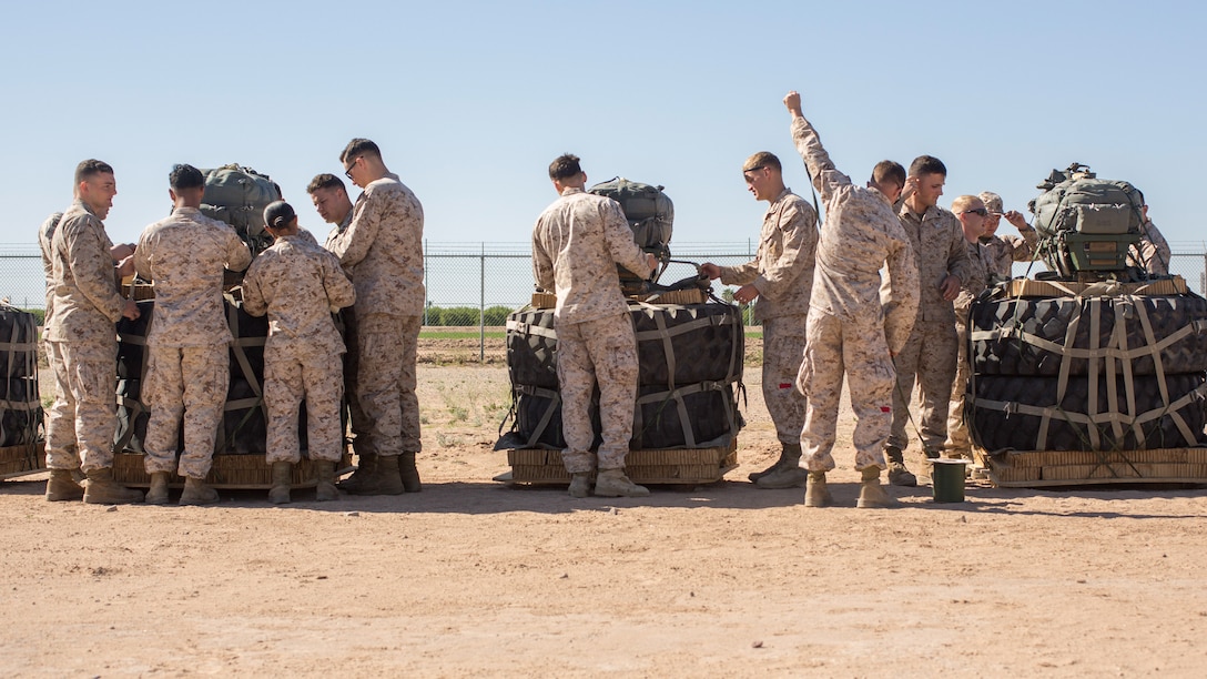 U.S. Marines prepare Joint Precision Airdrop Systems for flight during Weapons and Tactics Instructors Course 2-17 on Marine Corps Air Station, Yuma, Ariz., March 30, 2017. The JPADS uses GPS, a modular autonomous guidance unit, a parachute and electric motors to guide cargo to their targeted drop zones. The Marines were with Landing Support Company, Transportation Support Battalion, Combat Logistics Regiment 1, 1st Marine Logistics Group and Landing Support Company, 2nd TSB, CLR- 2, 2nd MLG. (U.S. Marine Corps photo by Lance Cpl. Roderick Jacquote)