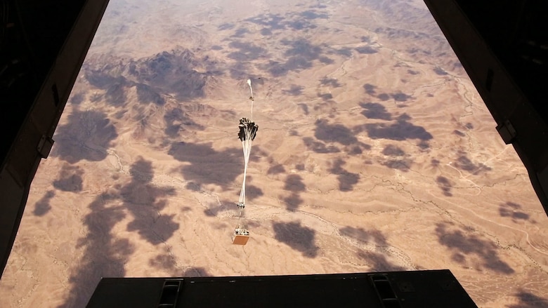 A Joint Precision Airdrop System drops from an MV-22 Osprey during testing of the system Aug. 26, 2014, at Yuma Proving Ground, Ariz. The JPADS systems use GPS, a modular autonomous guidance unit, or MAGU, a parachute and electric motors to guide cargo within 150 meters of their target points. To test its precision, the Marines used a series of palletized loads attached to parachutes with the GPS integrated system and dropped them from various heights. (U.S. Marine Corps photo by Sgt. Laura Gauna/ released)