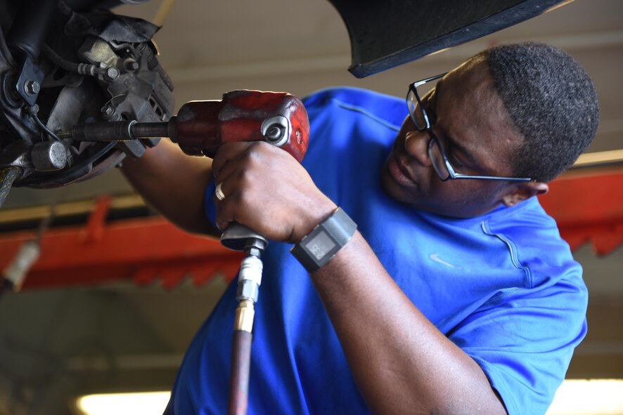 Tech. Sgt. Willie Gold, 437th Aircraft Maintenance Squadron crew chief, fixes the suspension on his son’s car in the Auto Skills Center at Joint Base Charleston, S.C. June 15, 2017. The ASC has 12 bays, nine with lifts, two flat bays and one motorcycle bay. Their rates are $5 per hour for the flat bays and $8 per hour for the lift bays.  (U.S. Air Force Photo / Airman Joshua Maund)