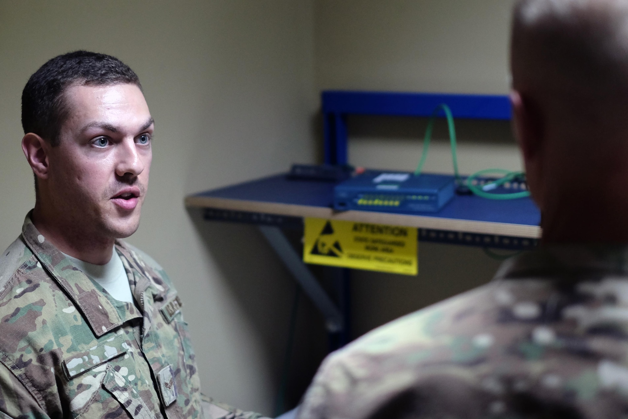 Staff Sgt. Tanner, 380th Expeditionary Communication Squadron Communications Fly-away Kit network manager explains how to establish a secure connection through a CFK June 27, 2017, at an undisclosed location in southwest Asia. In the event of a network outage, CFKs can be rapidly deployed to maintain operations. Recently CFKs gathered critical flight data during one such outage to ensure the mission for local aircraft. (U.S. Air Force photo by Senior Airman Preston Webb)