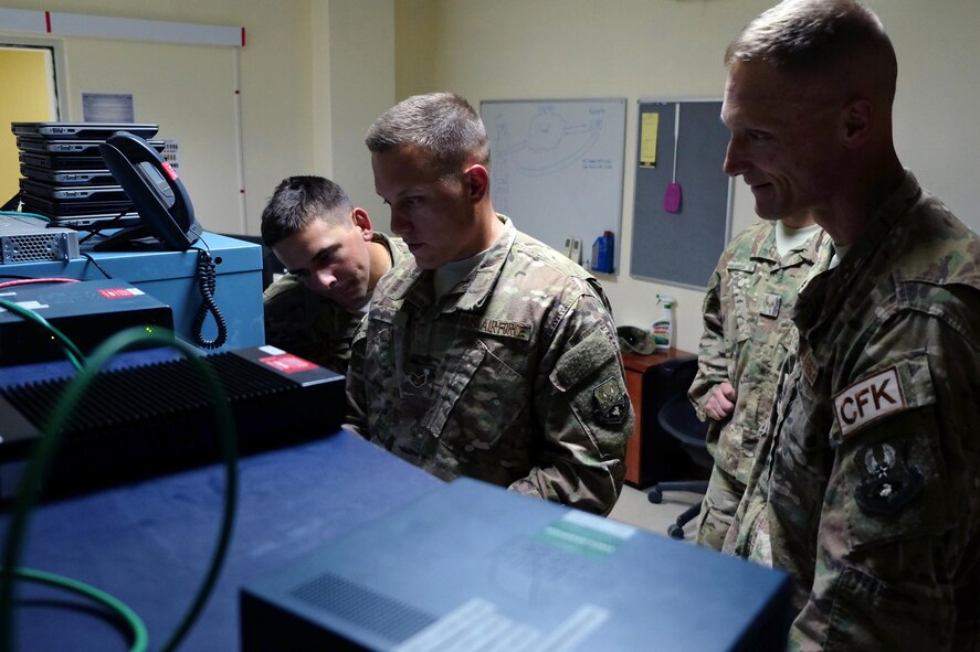 From right, Col. Dee Jay Katzer, 380th Air Expeditionary Mission Support Group commander, Staff Sgt. Craig, 380th Expeditionary radio frequency transmissions systems Communications Fly-away Kit 28 team lead, and Senior Airman Joseph, 380th ECS radio frequency transmissions systems CFK 30 team lead, test a secure connection June 27, 2017, at an undisclosed location in southwest Asia. In the event of a network outage, CFKs can be rapidly deployed to maintain operations. Recently CFKs gathered critical flight data during one such outage to ensure the mission for local aircraft. (U.S. Air Force photo by Senior Airman Preston Webb)
