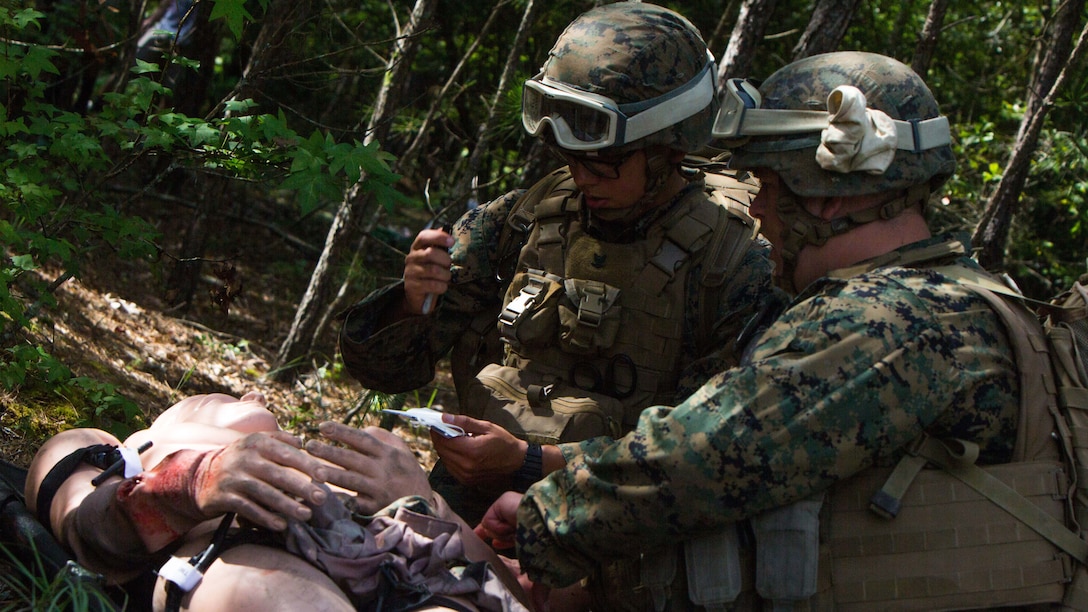 Seaman Tyler Kelly, left, and Petty Officer 3rd Class Ginio Mares, right, provides medical care to a dummy during a Tactical Evacuation Course at Camp Lejeune, N.C., June 27, 2017. The course consisted of corpsmen identifying dummy casualties and assessing them for injuries ranging from gunshot wounds, amputations to severe trauma and treating them accordingly, followed by stabilizing and evacuating the casualty with an MV-22 Osprey.