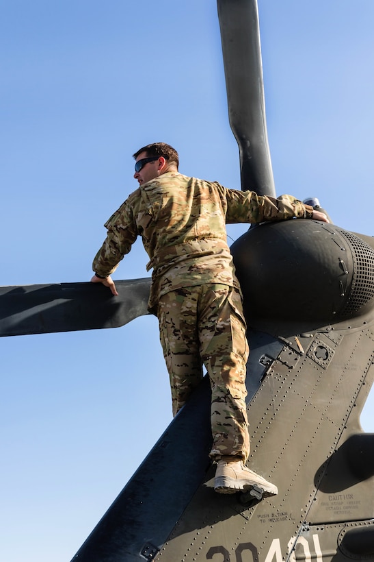 An Army pilot performs prefight checks on a UH-60M Black Hawk helicopter at Kandahar Airfield, Afghanistan, June 21, 2017. The pilot is a assigned to the 7th Infantry Division’s 16th Combat Aviation Brigade, Task Force Warhawk. Army photo by Capt. Brian Harris