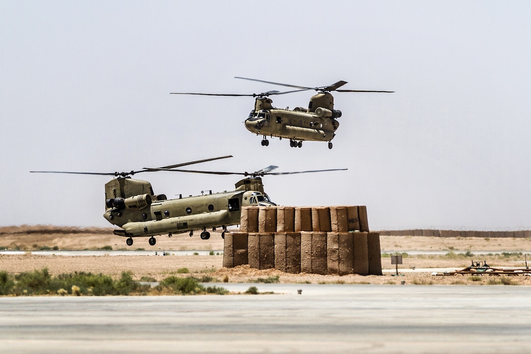 Two CH-47 Chinook helicopters prepare to land in Helmand province, Afghanistan, June 21, 2017. Army photo by Capt. Brian Harris
