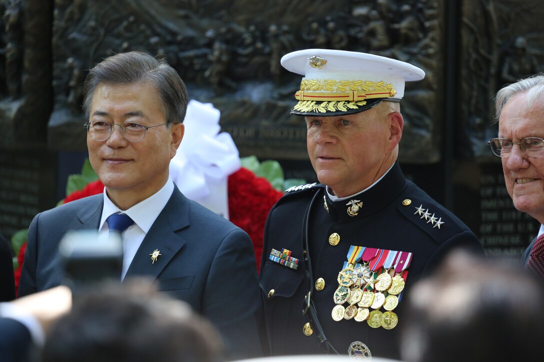 On Wednesday, June 28, 2017, members of the Marine Band supported a wreath-laying ceremony in honor of the Marines who fought in the Korean War. President Moon Jae-in of the Republic of Korea honored the Marines at the Korean War Chosin Monument at the National Museum of the Marine Corps. In 1950, President Moon's parents were able to flee to South Korea after the 1st Marine Division drove the enemy back. Today, he showed his gratitude for all the Marine Corps did for his family. (U.S. Marine Corps photo by Gunnery Sgt. Rachel Ghadiali/released)