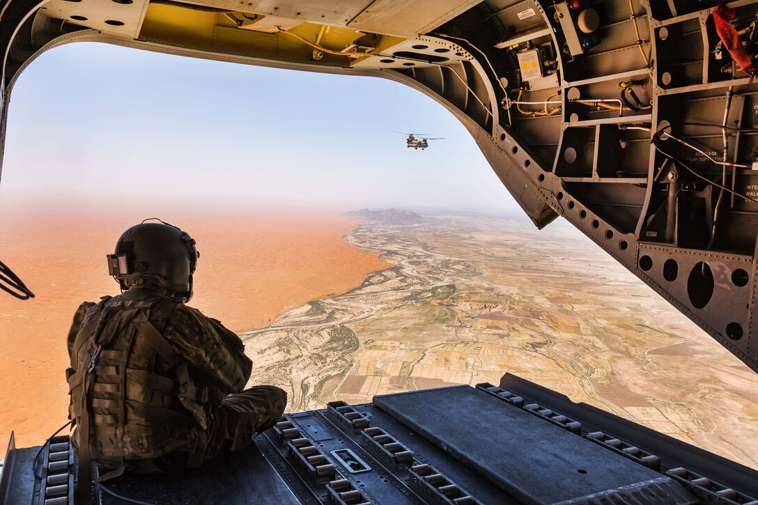 An Army Reserve pilot observes the Registan Desert, Afghanistan, from the back ramp of a CH-47 Chinook helicopter June 21, 2017. Army photo by Capt. Brian Harris