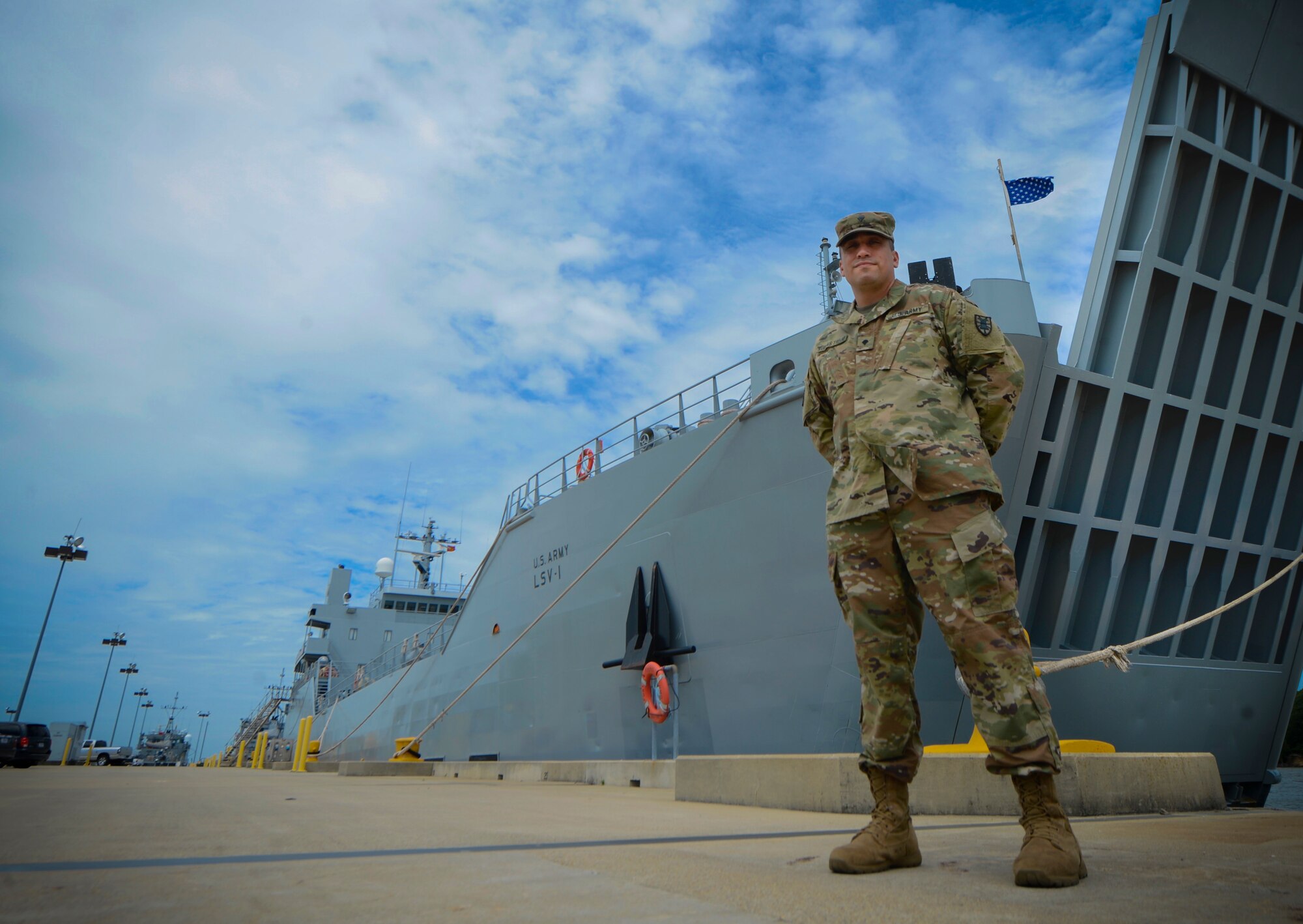 U.S. Army Spc. Miguel Ruelas Trejo, 335th Transportation Detachment, 7th Transportation Brigade (Expeditionary), quartermaster, stands next to the General Frank S. Besson-class logistics support vessel at Joint Base Langley-Eustis, Va., June 23, 2017. As an Army mariner, Ruelas Trejo, finds traveling around the world as the most rewarding part of his career-field. (U.S. Air Force photo/Airman 1st Class Kaylee Dubois)