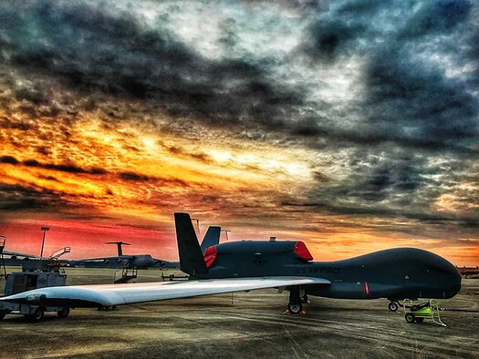 The RQ-4 Global Hawk that Team Robins maintenance professionals have been working on sits on the runway at Robins, June 29, 2017. Robins is the first and currently the only installation to have a building-based Launch and Recovery Element, allowing the aircraft to take off and land from this location. This is also the first time a Global Hawk has flown into an Air Force air logistics complex. Warner Robins Air Logistics Complex maintenance professionals meticulously painted the aircraft to prevent corrosion and finished the job ahead of schedule. While a programmed depot maintenance requirement for Global Hawk has not been established, the Air Force recognizes that having an organic maintenance capability for Global Hawk enhances our ability to manage the fleet and keep this resource flying.(U.S. Air Force photo illustration by Claude Lazzara)