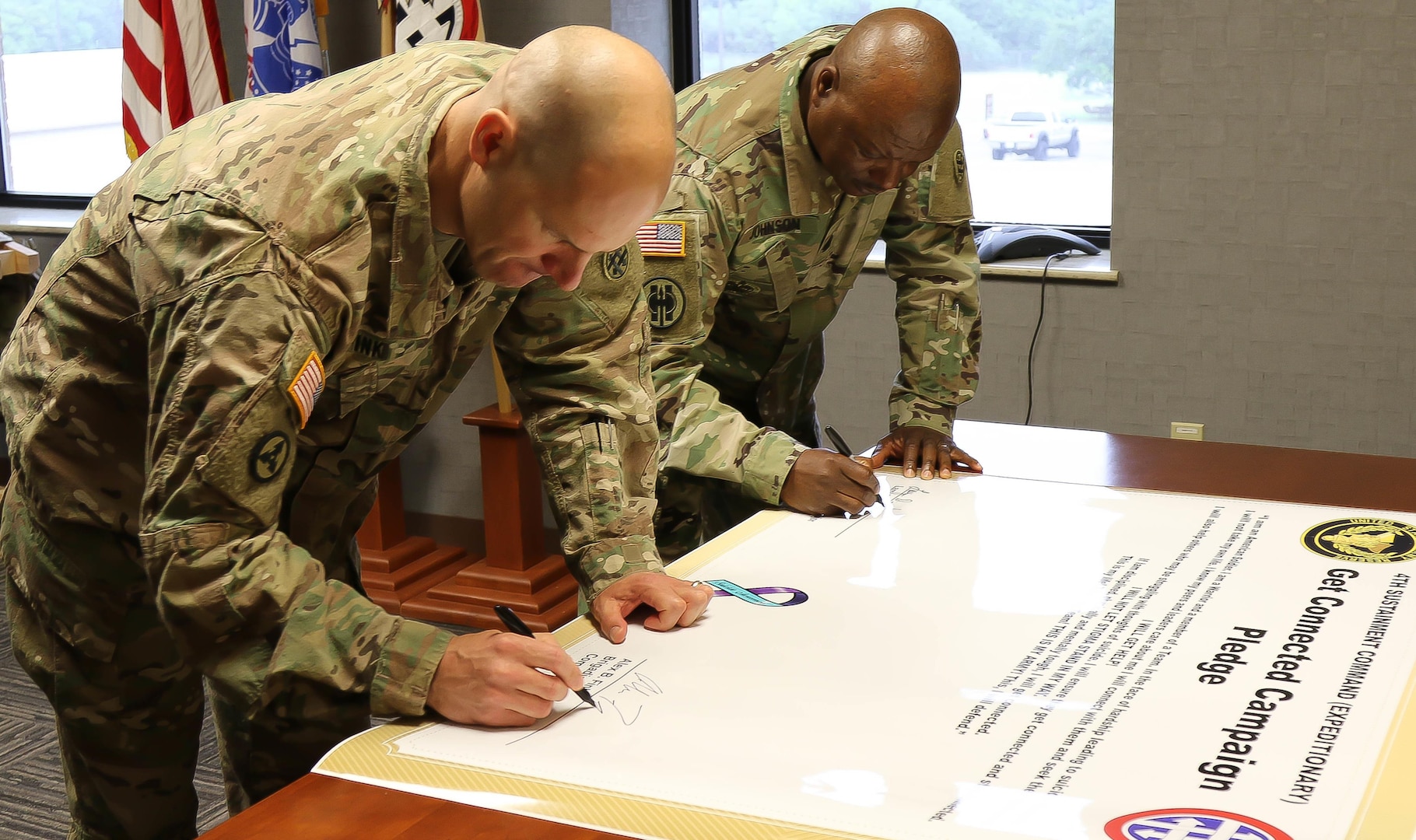 U.S. Army Reserve Brig. Gen. Alex Fink, Commanding General of the 4th Sustainment Command (Expeditionary), and U.S. Army Reserve Command Sgt. Maj. Larry Johnson, Command Sergeant Major of the 4th ESC, sign the Get Connected Pledge to end the stigma around asking for help with suicidal thoughts at Joint Base San Antonio, May 9, 2017. The Get Connected Campaign aims to prevent suicide by teaching Soldiers how to prevent feelings of isolation. 