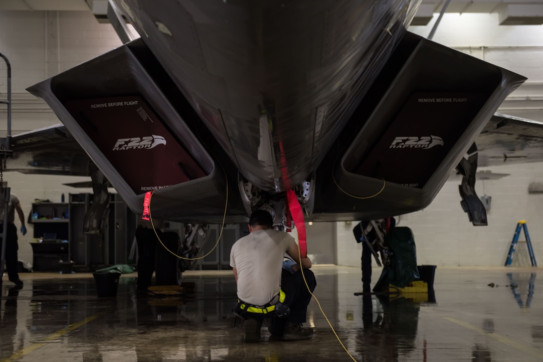 U.S. Air Force Airman 1st Class Joshua Aujero, 1st Aircraft Maintenance Squadron, 27th Aircraft Maintenance Unit crew chief, cleans the front landing gear of a F-22 Raptor in the wash rack at Joint Base Langley-Eustis, Va., June 19, 2017. The wash rack is not only used to clean the F-22 but is also used for inspections. (U.S. Air Force photo/Staff Sgt. J.D. Strong II)