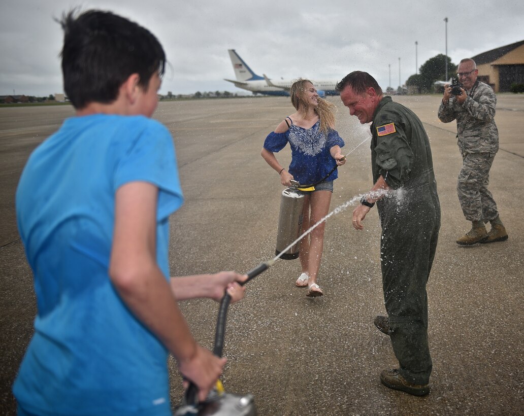The 932nd Airlift Wing welcomed Lt. Col. Robert Witzel (center in flight suit) back from his final United States Air Force Reserve Command flight on June 22, 2017, at 1500 hours, on the Scott Air Force Base, Illinois, flight line. A light rainstorm let up just about the time he and other crew members landed the C-40 aircraft. He waved to the crowd and walked down the stairs from the wing's beautiful C-40 for the last time, and thanked everyone for coming out to his historical "fini flight". Family members gave him the traditional "splash down" welcome with water squirting from fire extinguishers.  He retires as a command pilot with more than 8,500 flying hours in several aircraft including the C-141, the C-9 and finally the C-40C plane belonging to the Illinois wing, which is aligned under 22nd Air Force, and the Air Force Reserve Command.  (U.S. Air Force photo by Christopher Parr)