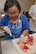 Jennifer Brown, KC-46 Configuration Management, cuts the calyx off of a fresh strawberry at the House of Bread Dayton during a KC-46 Program Office volunteer opportunity there June 28, 2017. House of Bread Dayton says they count on volunteers like these Airmen to serve between 200 and 300 meals every day of the year to Dayton community members in need. (U.S. Air Force photo/John Harrington)