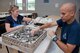 Lt. Col. Carlos Quinones (right), KC-46 Program Officer Director of Operations and volunteer opportunity event coordinator, prepares silverware with his wife, Rebecca, in preparation for serving more than 270 meals to Dayton community members in need at the House of Bread Dayton June 28, 2017. More than a dozen volunteers from the KC-46 Program Office donated five hours of their time performing a wide range of activities including prepping and cooking meals, serving, cleaning and grounds keeping as part of the event. Lt. Col. Quinones says that Dayton has always been very welcoming to military personnel and the group was trying to do their part to give a little back. Jennifer Burns, House of Bread Dayton operations manager, says the size of the KC-46 group not only allowed for meal service, but to complete a lot of needed facility upkeep. (U.S. Air Force photo/John Harrington)