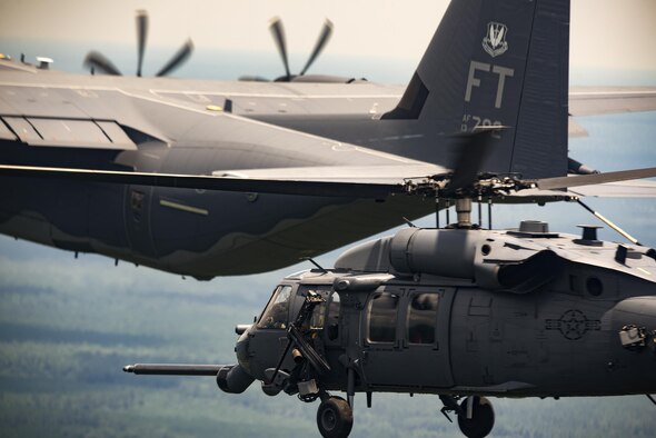 An HH-60G Pave Hawk from the 41st Rescue Squadron approaches an HC-130J Combat King II from the 71st RQS to conduct aerial refueling during 23d Wing commander Col. Thomas Kunkel’s fini-flight, June 27, 2017, at Moody Air Force Base, Ga. The fini-flight is a long-standing Air Force tradition that occurs when a pilot departs from the base. Upon completion of their final flights, military aviators are hosed down with water or champagne by their family and friends before they depart their unit. (U.S. Air Force photo by Staff Sgt. Ryan Callaghan)