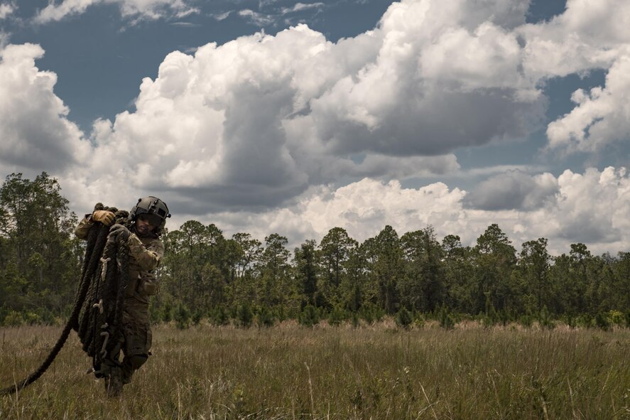 Tech. Sgt. Brandon Middleton, 41st Rescue Squadron special missions aviator, recovers a 60-foot rope from a landing zone, June 27, 2017, at Moody Air Force Base, Ga. The HH-60G Pave Hawk flies with two pilots and two SMAs, who are responsible for pre-flight aircraft inspections, passengers, cargo and operating the aircraft’s weapons. (U.S. Air Force photo by Staff Sgt. Ryan Callaghan)