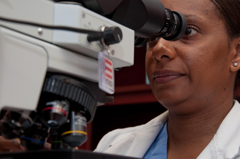 Maj. (Dr.) Michelle R. Williams, Wright-Patterson Medical Center staff pathologist, reviews cytology slides looking for atypical cells or cancer. Williams looks at approximately a dozen such cases per day in order to provide accurate diagnoses of disease so that doctors can properly treat patients. (U.S. Air Force photo/John Harrington)
