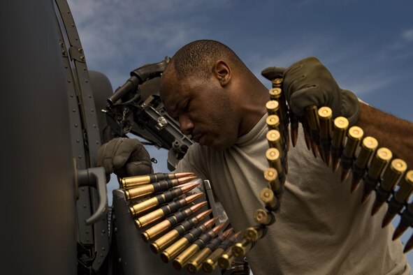 Tech. Sgt. Brandon Middleton, 41st Rescue Squadron special missions aviator, loads .50 caliber rounds into a machinegun aboard an HH-60G Pave Hawk, June 27, 2017, at Moody Air Force Base, Ga. The HH-60G flies with two pilots and two SMAs, who are responsible for pre-flight aircraft inspections, passengers, cargo and operating the aircraft’s weapons. (U.S. Air Force photo by Staff Sgt. Ryan Callaghan)