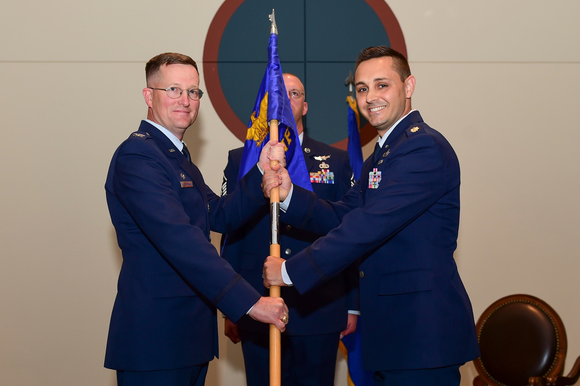 Maj. Eric Lizon, 460th Contracting Flight incoming commander, receives the guidon, symbolizing the official change of command June 28, 2017, on Buckley Air Force Base, Colo. The 460th CONF supports the base with millions of dollars in contracts each year. (U.S. Air Force photo by Airman Jacob Deatherage/Released)