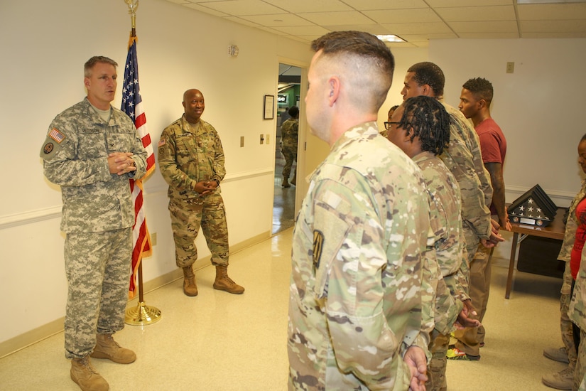 Col. Todd Peterson (left), force management director and acting G-3 operations officer, 335th Signal Command (Theater), and Command Sgt. Maj. Ronnie Farmer, command sergeant major, 335th SC (T) speak to a group of twelve Soldiers assigned to Detachment 1, 335th SC (T), during a welcome home warrior citizen ceremony at the Killeen Regional Airport, Killeen, Texas June 28.  The Soldiers returned from a nine-month deployment where their mission  providing communications support to a special operations joint task force, as part of Operation Inherent Resolve.  (Official U.S. Army Reserve photo by Sgt. 1st Class Brent C. Powell)