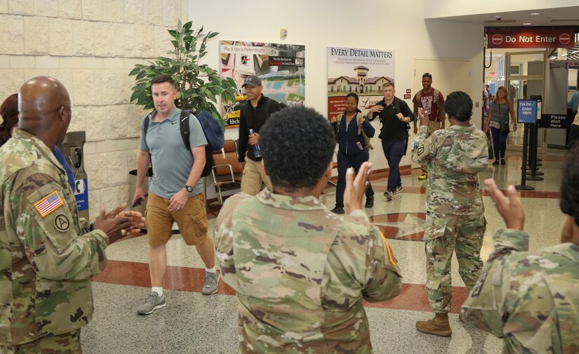 A team of twelve Soldiers, assigned to Detachment 1, 335th Signal Command (Theater), arrive to cheers and applause at the Killeen Regional Airport, Killeen, Texas June 28, after returning from a successful nine-month deployment.  The Soldiers deployed last year with a mission of providing communications support to a special operations joint task force, as part of Operation Inherent Resolve.  (Official U.S. Army Reserve photo by Sgt. 1st Class Brent C. Powell)