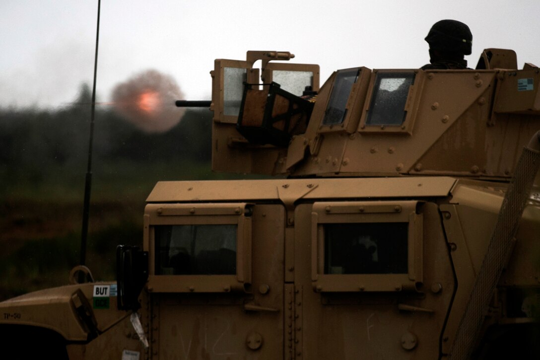 A U.S. Marine assigned Black Sea Rotational Force 17.1, fires a .50 caliber machine gun at a Adazi Military Base range, Latvia, June 9, 2017. The event was a part of Exercise Saber Strike 17, a multinational training exercise with NATO allies and partner nations to increase cohesion and skills through combined-arms training Marine Corps photo by Cpl. Sean J. Berry