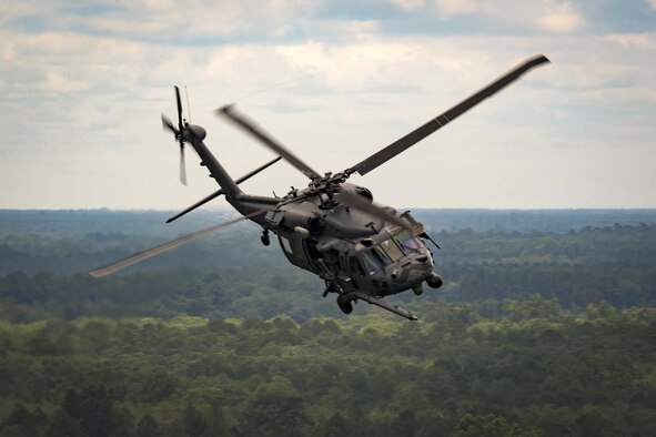 An HH-60G Pave Hawk from the 41st Rescue Squadron flies over Grand Bay Bombing and Gunnery Range during 23d Wing commander Col. Thomas Kunkel’s fini-flight, June 27, 2017, at Moody Air Force Base, Ga. The fini-flight is a long-standing Air Force tradition that occurs when a pilot departs from the base. Upon completion of their final flights, military aviators are hosed down with water or champagne by their family and friends before they depart their unit. (U.S. Air Force photo by Staff Sgt. Ryan Callaghan)