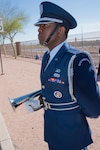 U.S. Air Force 2nd Lt. Tinashe Machona, assigned to the 161st Air Refueling Wing, stands at attention in a color guard detail before playing taps on his trumpet during Copper 5, an air crew memorial ceremony, at Goldwater Air National Base, Phoenix Ariz., March 13, 2017. 