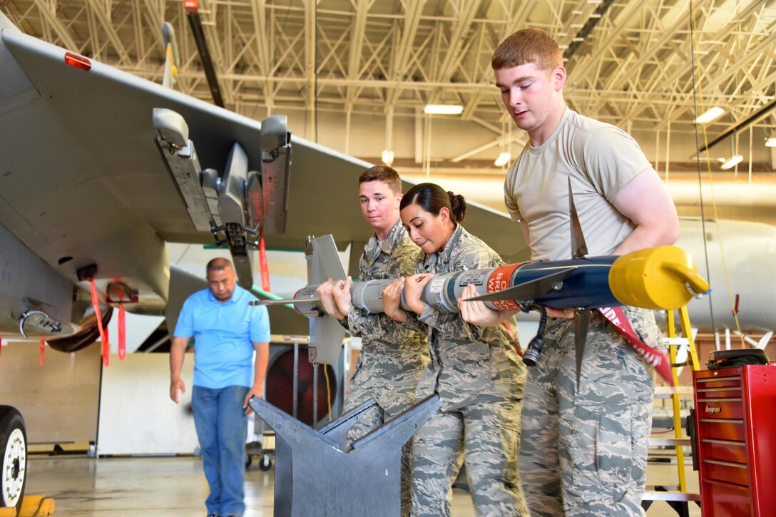 Airmen Anthony Williams, Tyana Haylock and Bradd Hammond, 363rd Training Squadron F-15 Eagle aircraft armament systems apprentice students unload air-to-air munitions from aircraft at Sheppard Air Force Base, Texas. The 363rd Training Squadron provides training for armament, munitions, nuclear weapons and maintenance scheduling and analysis. (U.S. Air Force photo/Liz H. Colunga)