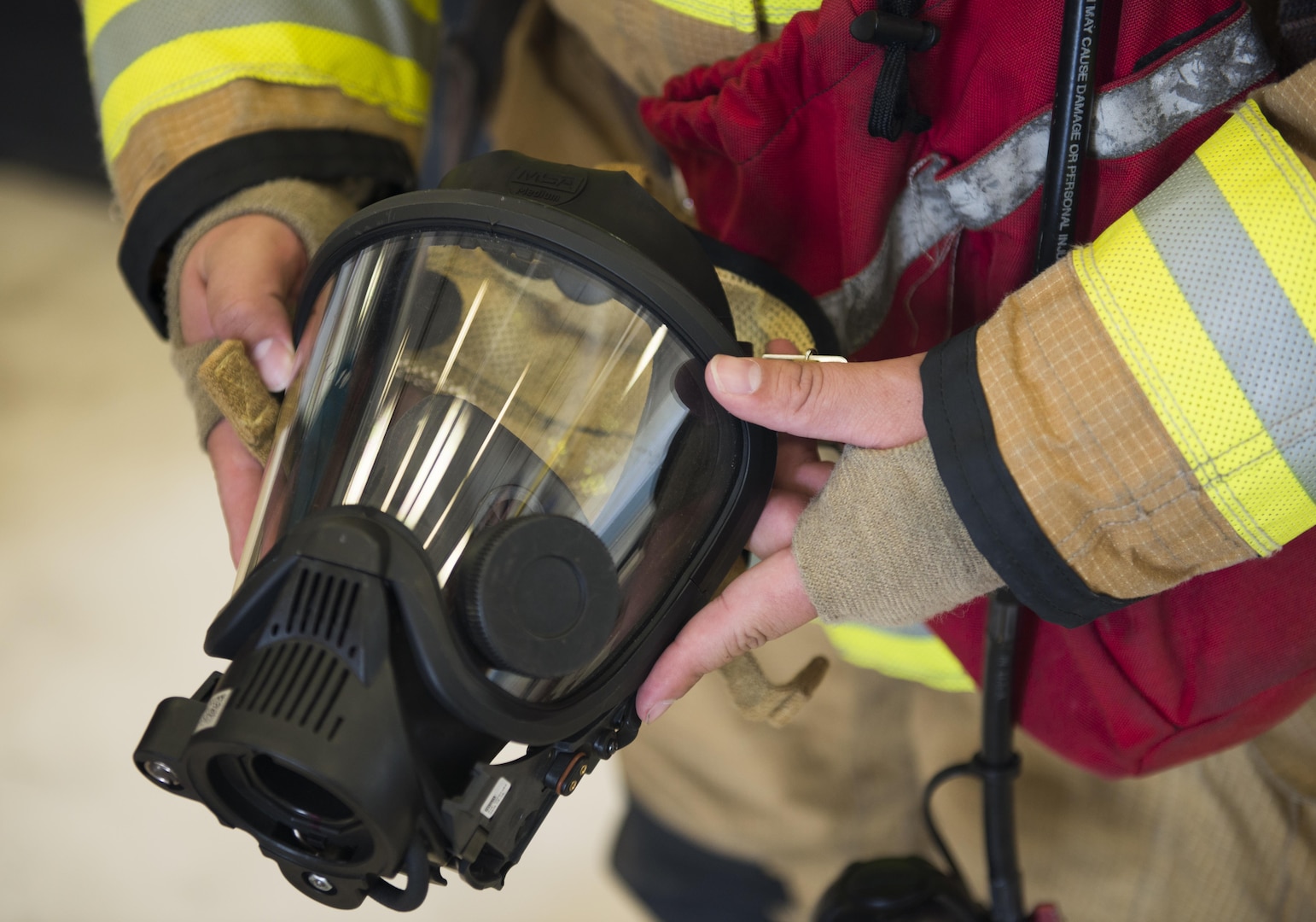 Jeffery Pardo (left), 502nd Civil Engineering Squadron firefighter, shows off his breathing mask to children from Vibrant ABA Solutions during a open house tour of Fire Station 2 June 23, 2017, at Joint Base San Antonio-Lackland, Texas. (U.S. Air Force photo by Senior Airman Krystal Wright)