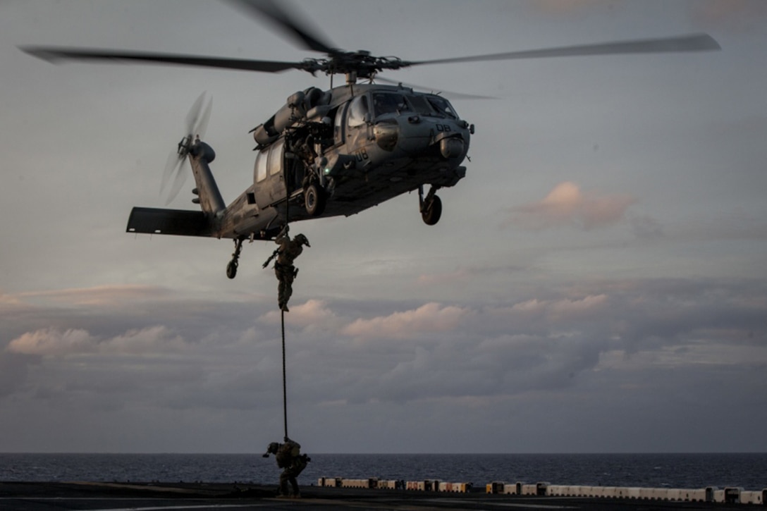 Marines with Force Reconnaissance Platoon, Maritime Raid Force, 31st Marine Expeditionary Unit rappel from a Navy MH-60S Seahawk helicopter during training aboard the amphibious assault ship USS Bonhomme Richard while underway in the Pacific Ocean, June 25, 2017. Marine Corps photo by Lance Cpl. Stormy Mendez