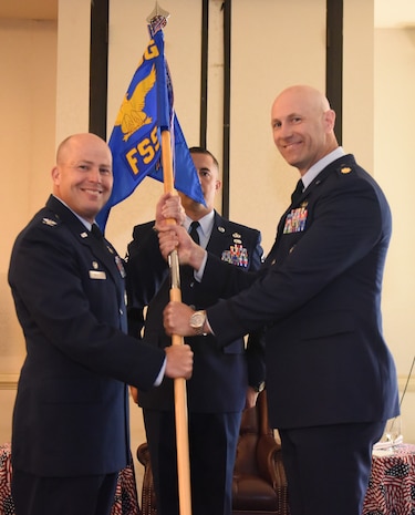 Col. Richard Mathews, left, 628th Mission Support Group commander, passes the 628th Force Support Squadron guideon to incoming commander, Maj. William Parker during the 628th FSS change of command ceremony, June 29, 2017 at Joint Base Charleston, SC. Parker came to Charleston from Osan Air Force Base, Republic of Korea where he commanded the 51st FSS.