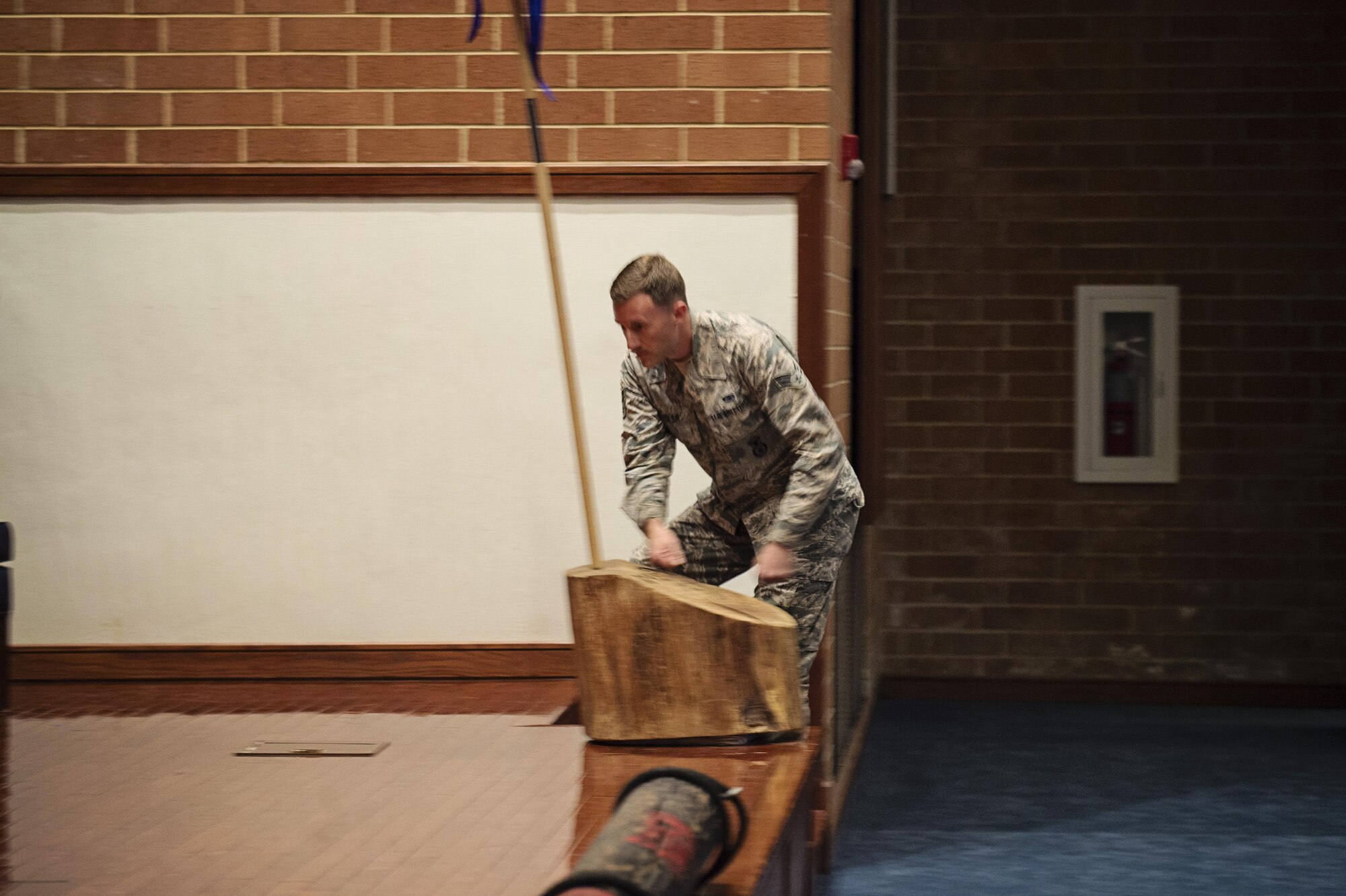 Senior Airman Johnathan Heisler, 512th Security Forces Squadron reservist, touches the "stump" symbolizing his graduation from the Phoenix Raven training June 26, 2017, at Joint Base McGuire-Dix-Lakehurst, New Jersey. More commonly called "Ravens," this small community of specialized security forces Airmen are trained in securing Air Mobility Command aircraft in dangerous or unknown airfields. (U.S. Air Force photo/Capt. Bernie Kale)