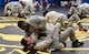Senior Airman Jerome Scurry (top), 512th Security Forces Squadron reservist, wrestles with another trainee during Phoenix Raven training June 15, 2017, at Joint Base McGuire-Dix-Lakehurst, New Jersey.Raven training includes instruction and realistic practical exercises in antiterrorism and force protection, weapon system security, verbal judo, combatives, tactical baton employments and advanced firearms proficiency. (U.S. Air Force photo/Capt. Bernie Kale)