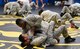 Senior Airman Jerome Scurry (top), 512th Security Forces Squadron reservist, wrestles with another trainee during Phoenix Raven training June 15, 2017, at Joint Base McGuire-Dix-Lakehurst, New Jersey.Raven training includes instruction and realistic practical exercises in antiterrorism and force protection, weapon system security, verbal judo, combatives, tactical baton employments and advanced firearms proficiency. (U.S. Air Force photo/Capt. Bernie Kale)