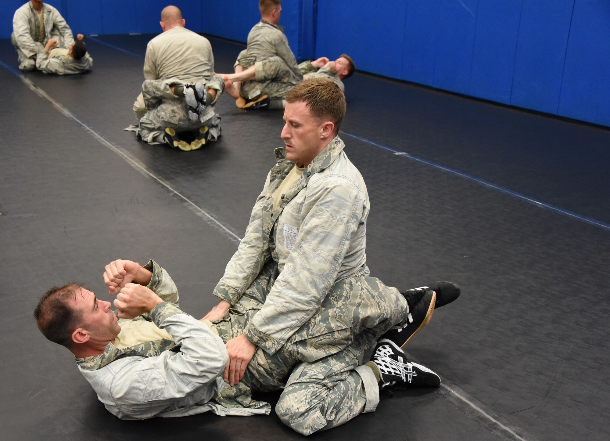 Senior Airman Johnathan Heisler (top), 512th Security Forces Squadron reservist, trains in combatives with another trainee during Phoenix Raven training June 15, 2017, at Joint Base McGuire-Dix-Lakehurst, New Jersey. More commonly called "Ravens," this small community of specialized security forces Airmen are trained to detect, deter and counter threats to Air Mobility Command, Air National Guard and Air Force Reserve aircraft. (U.S. Air Force photo/Master Sgt. Jaimie Powell)