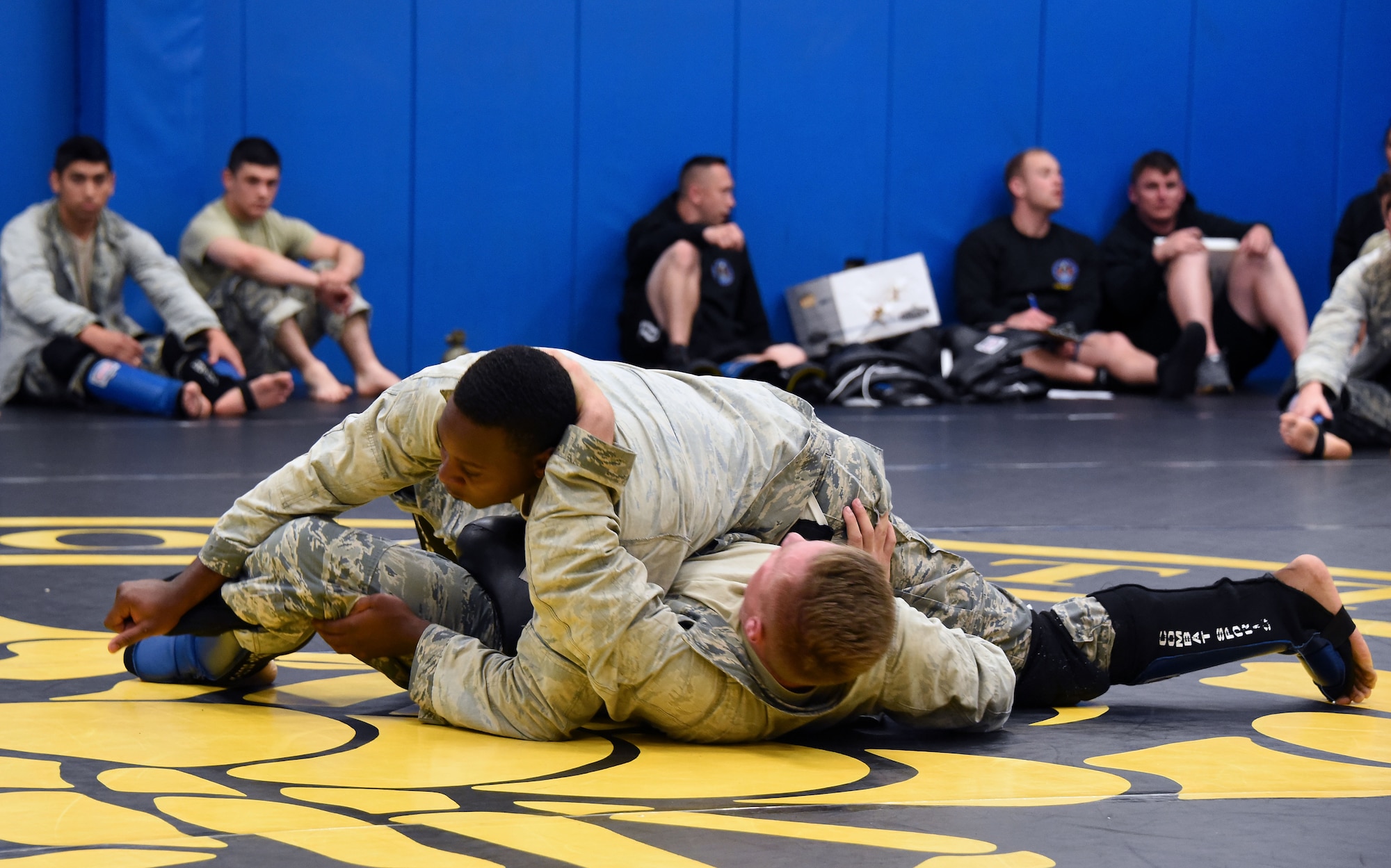 Senior Airman Jerome Scurry (top), 512th Security Forces Squadron reservist, wrestles with another trainee during Phoenix Raven training June 15, 2017, at Joint Base McGuire-Dix-Lakehurst, New Jersey.Raven training includes instruction and realistic practical exercises in antiterrorism and force protection, weapon system security, verbal judo, combatives, tactical baton employments and advanced firearms proficiency. (U.S. Air Force photo/Master Sgt. Jaimie Powell)