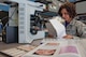 Maj. (Dr.) Luisa Watts, Wright-Patterson Medical Center staff pathologist, reviews a patient’s file while making a molecular determination of what could be causing the patient’s symptoms. Watts, along with three other staff pathologists at the WPMC, use information doctors provide, along with reviews of biological materials and reference materials, in forming their diagnoses. (U.S. Air Force photo/John Harrington) 