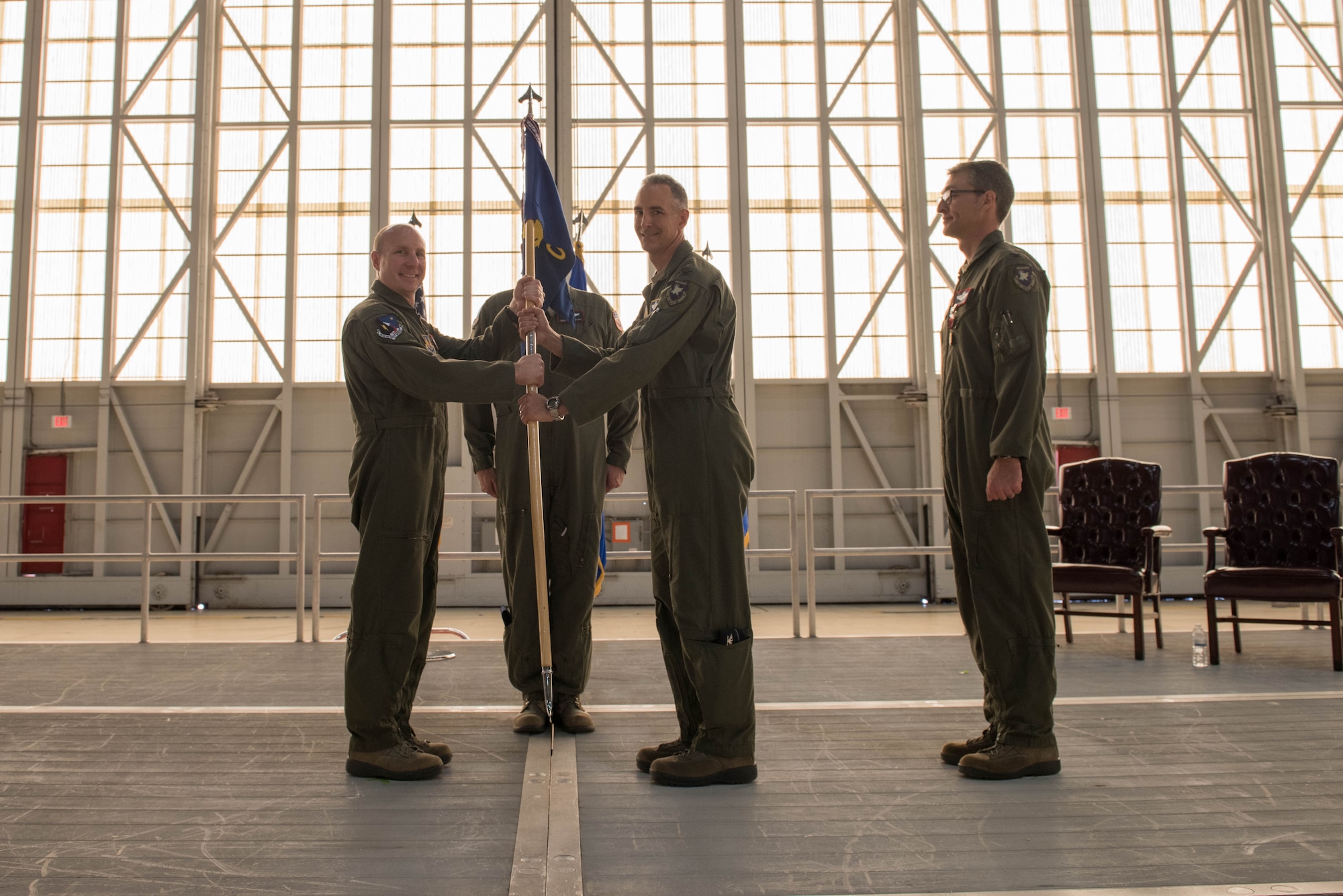 Brig. Gen. Carl Schaefer, 412th Test Wing commander (left), and Col. Christopher Spinelli, 412th Operations Group commander, pose for a photo with the 412th OG guidon in Hangar 1600 June 26. Spinelli assumed command of the group from Col. Scott Cain (right) who led the unit for the past two years. (U.S. Air Force photo by Joseph Sebastian Pol Gocong)


